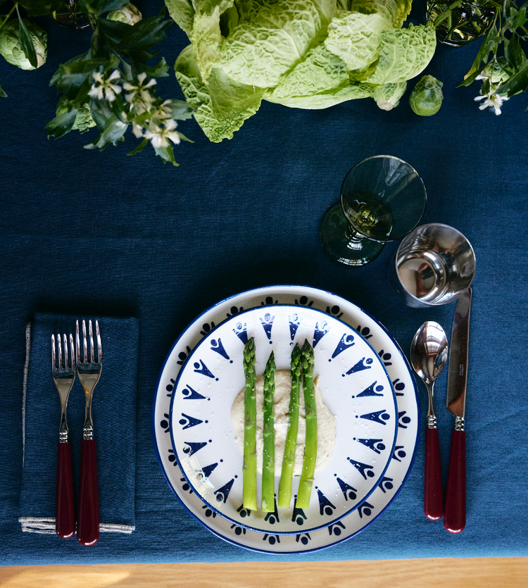 dish with asparagus table with plates and vegetable centerpiece