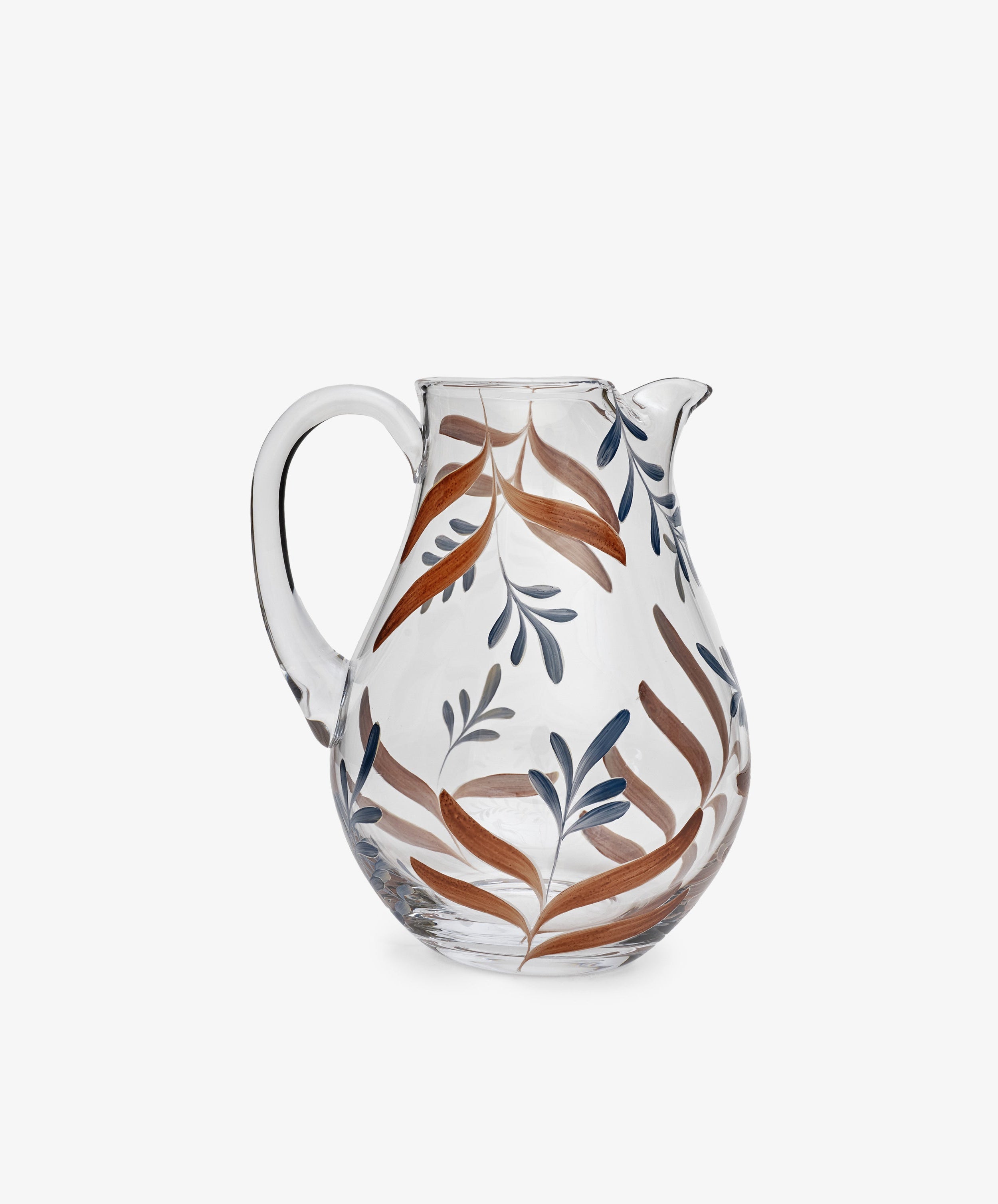 Botanical Jug: A clear glass pitcher with a handle, adorned with hand-painted brown and blue leaf patterns—unique tableware that stands out against a plain white background.