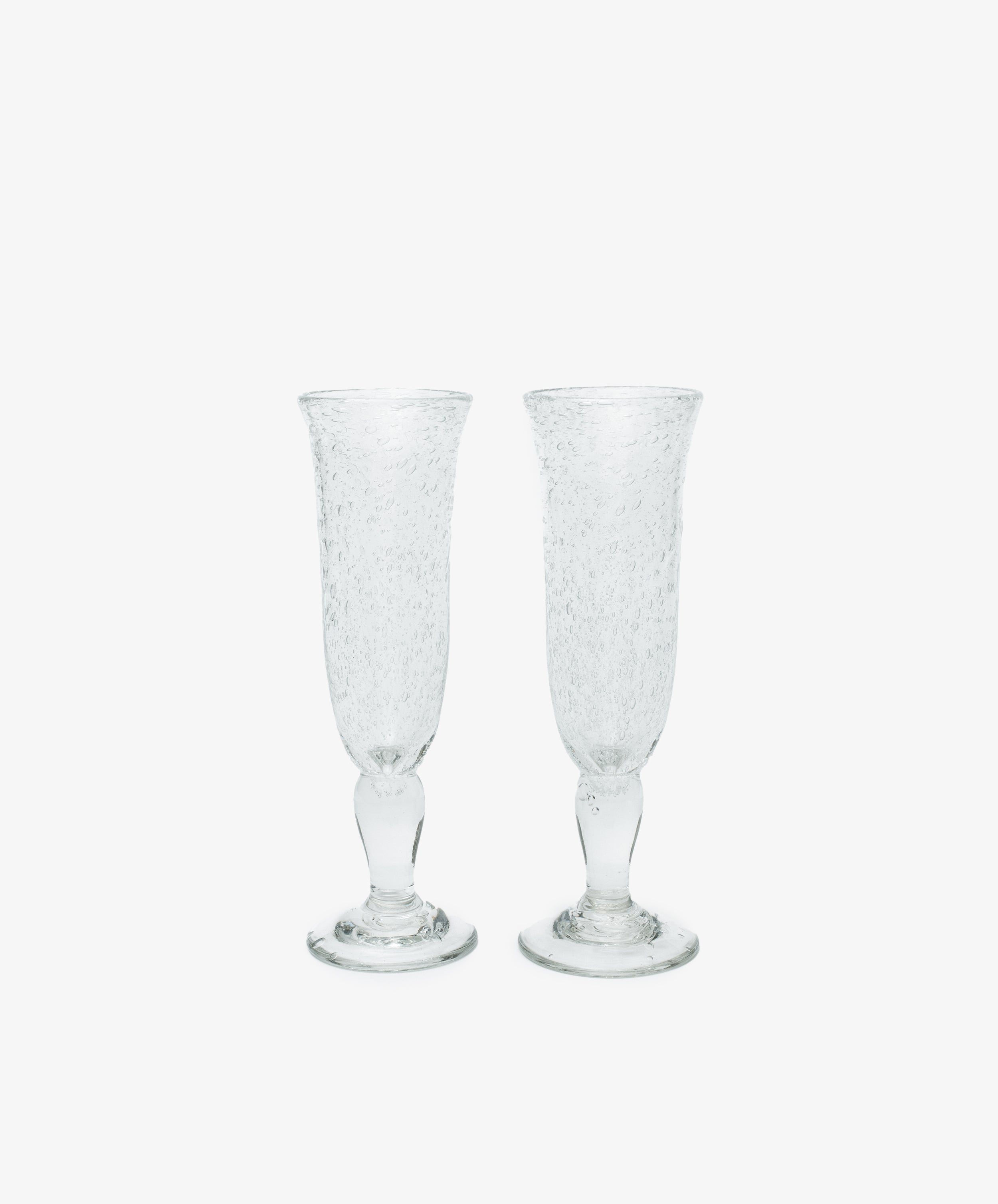 Two Lauren Champagne Glasses, set of 2, with clear textured glass and delicate air bubbles, are displayed side by side on a plain white background.