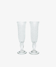 Two Lauren Champagne Glasses, set of 2, with clear textured glass and delicate air bubbles, are displayed side by side on a plain white background.