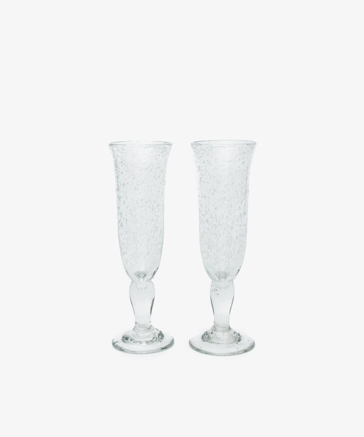 Two Lauren Champagne Glasses, set of 2, with clear textured glass and delicate air bubbles, are displayed side by side on a plain white background.