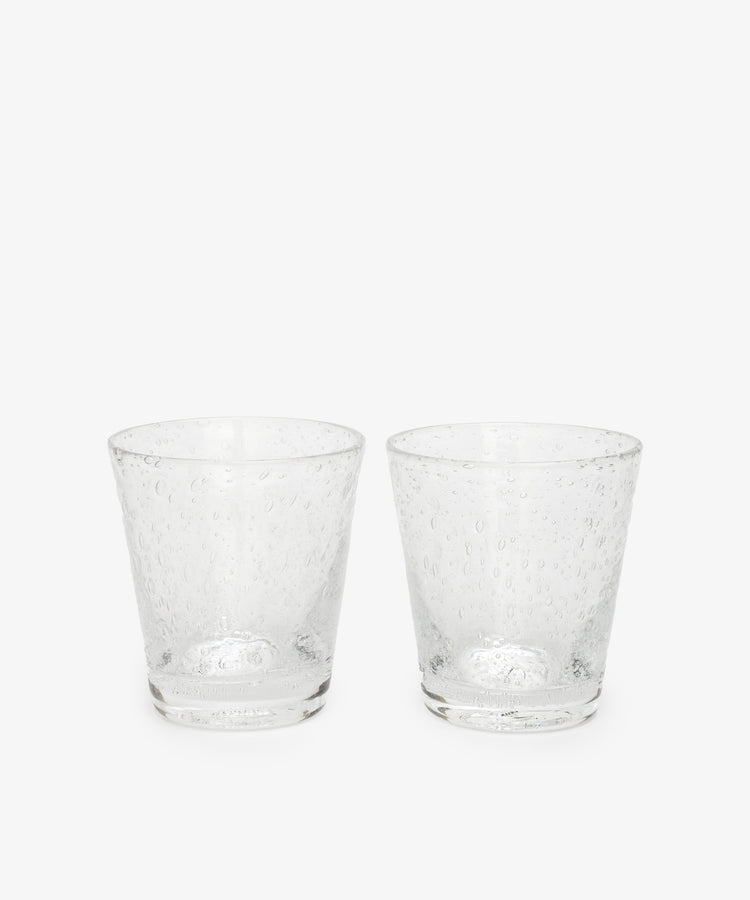 The Lauren Water Glass, Set of 2, features clear, textured glass tumblers with delicate air bubbles across their translucent surfaces, displayed side by side on a plain white background.