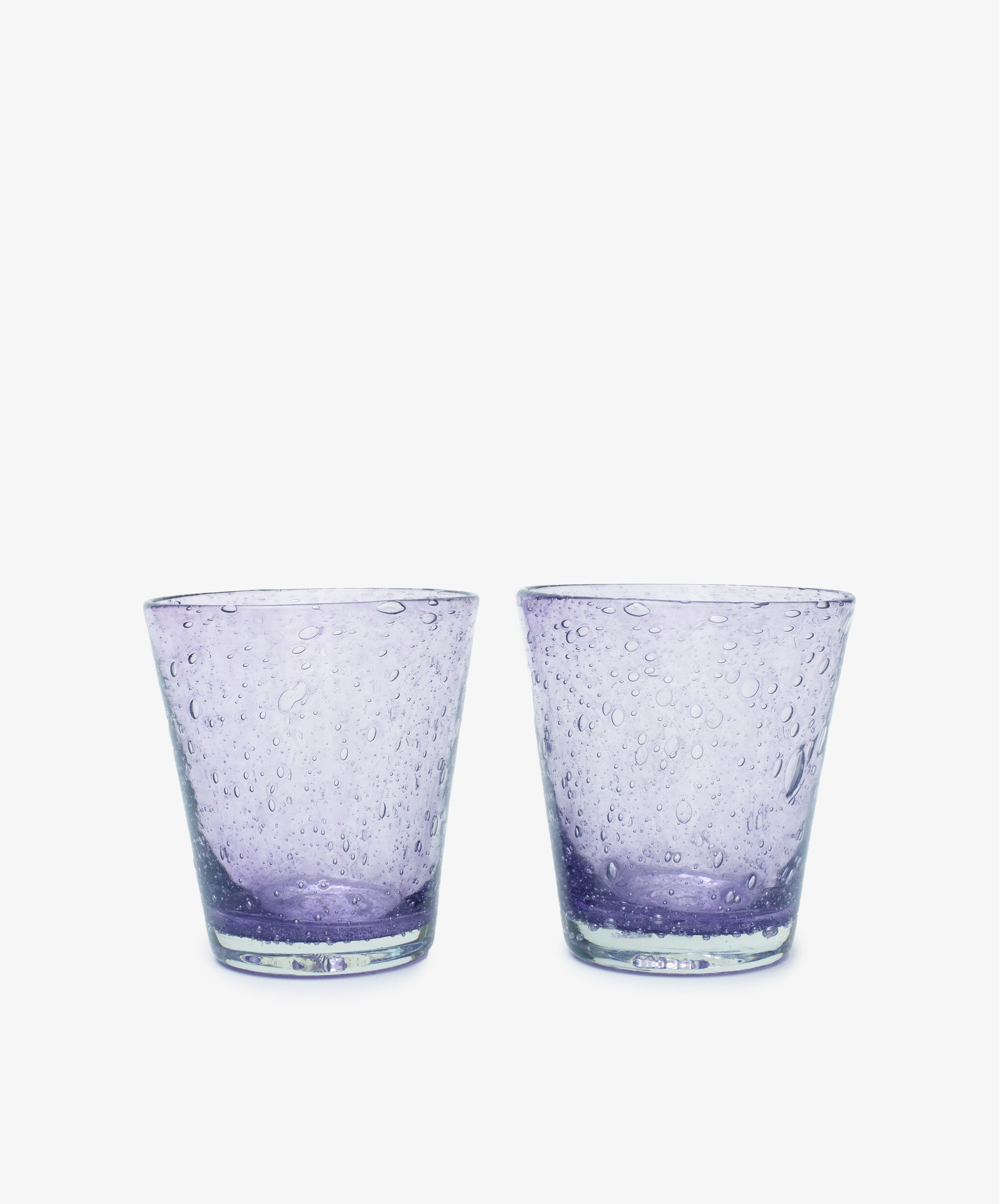A set of two Lauren Water Glasses, crafted in clear purple glass with a textured bubble pattern and translucent finish, are displayed side by side against a white background.