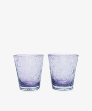 A set of two Lauren Water Glasses, crafted in clear purple glass with a textured bubble pattern and translucent finish, are displayed side by side against a white background.