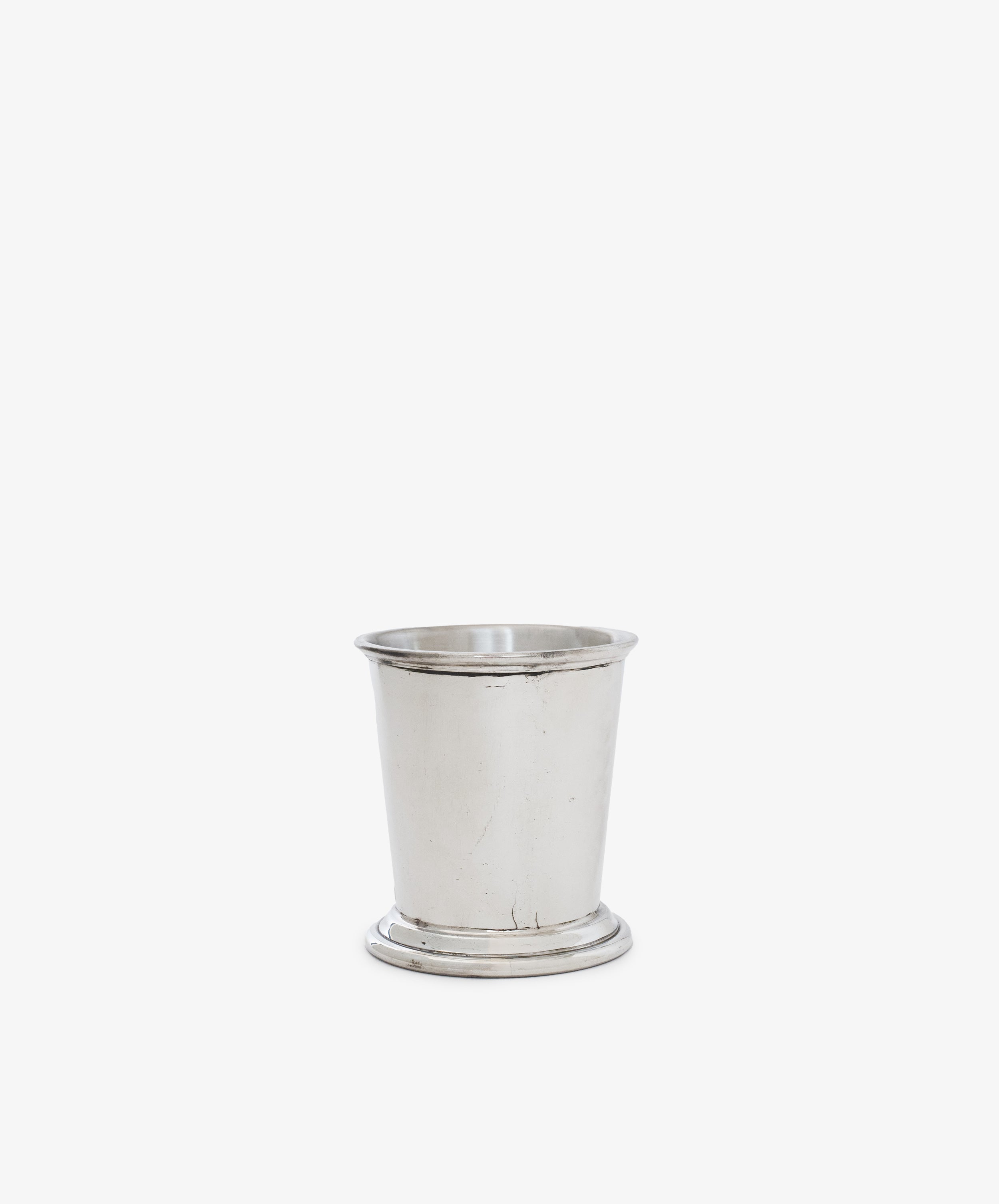 The Cleo Cigarette Cup is a plain pewter cup with a flared rim and slightly wider base, displayed against a white background—a timeless addition to any bar collection.
