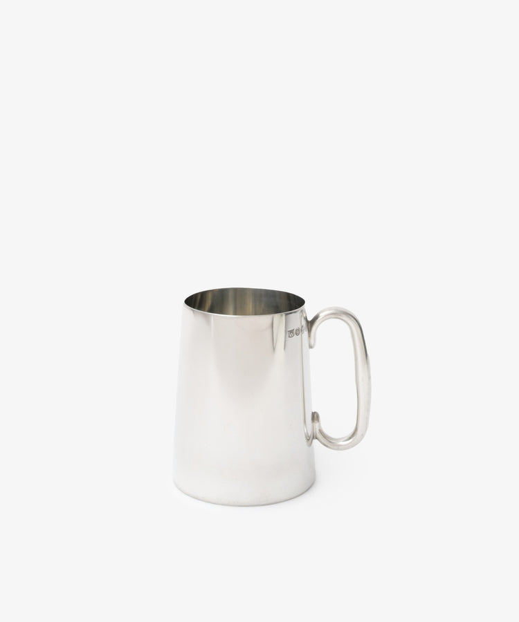 The Harry Tankard—a sleek, polished silver metal mug with handle—offers contemporary drinkware style, ideal for modern settings.