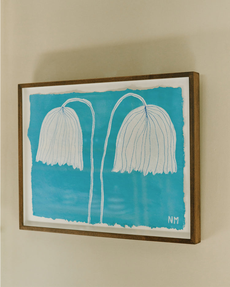 blue and white floral painting framed on wall