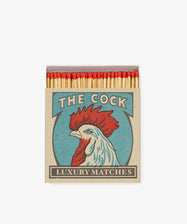 The Cock, Luxury Matches by Archivist Gallery. Graphic illustrated rooster box in red and blue with matches peeking out.