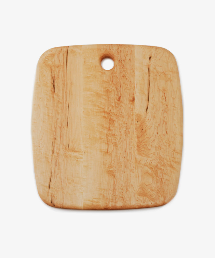 Birds Eye Maple Serving Board. Rounded edge extra large rectangular wooden board with circular hole at top centre.