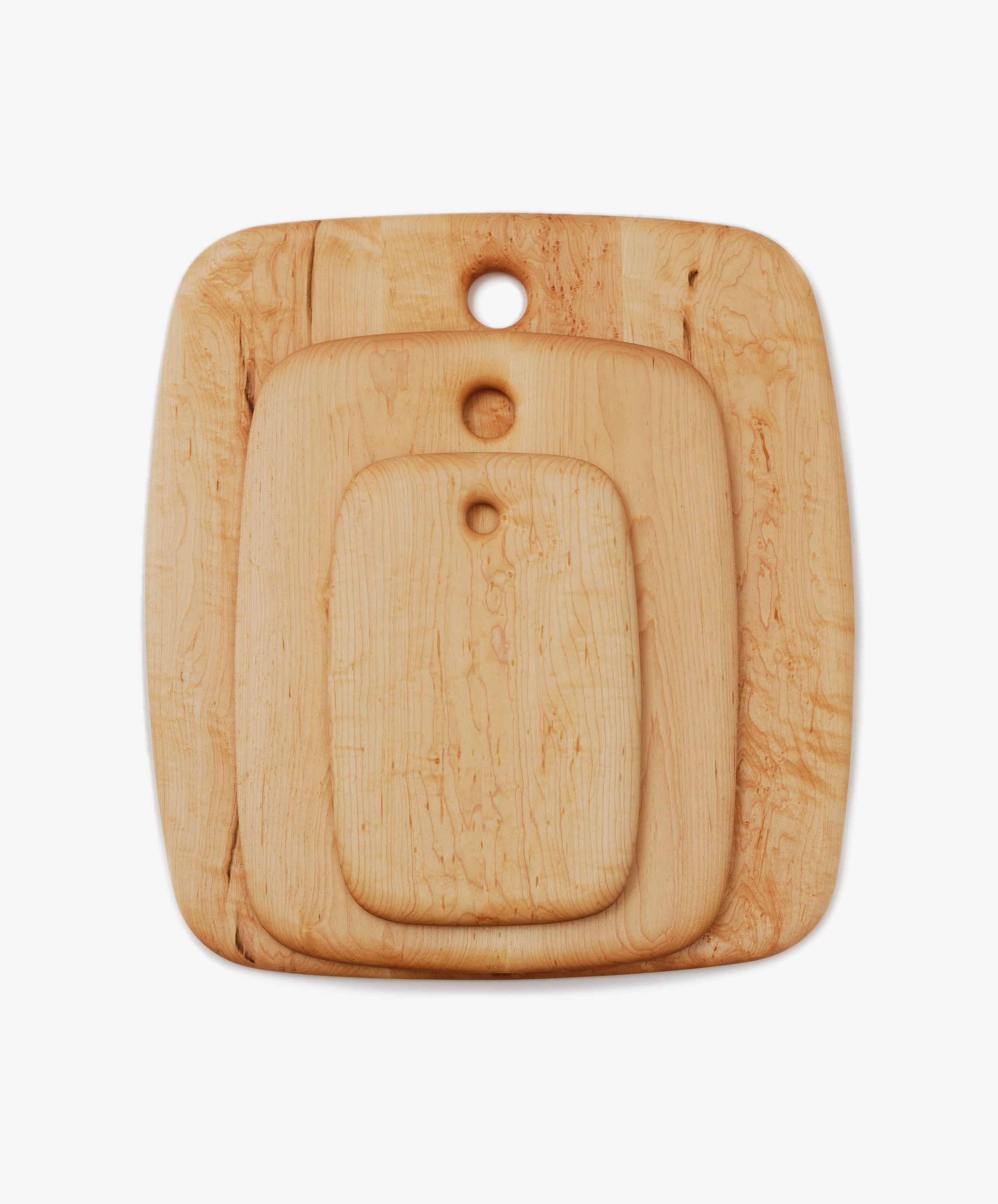 Nested maple chopping boards in three different sizes, overhead view.