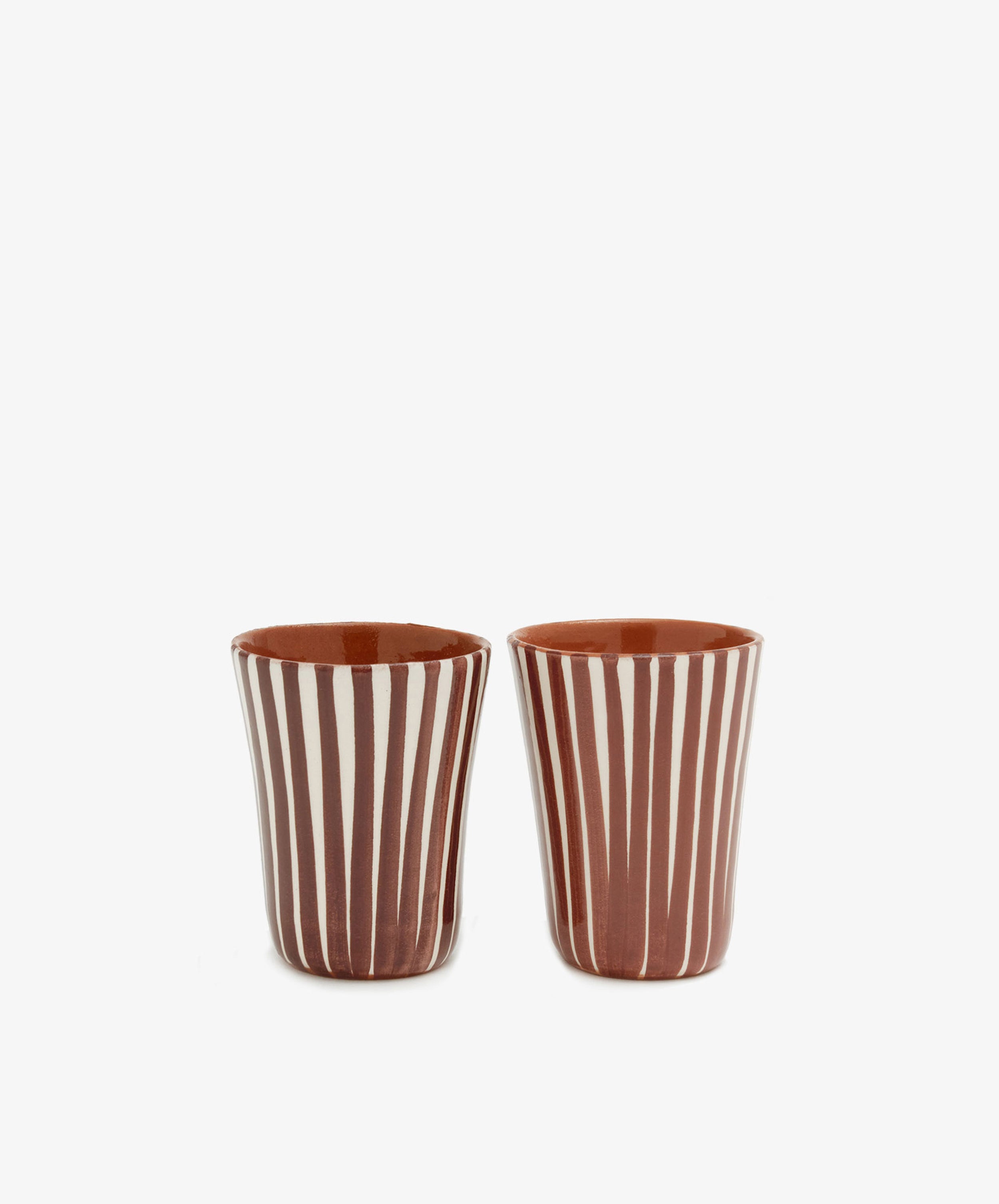 Two chic, handmade Natalia Espresso Cups (set of 2) featuring vertical white and brown stripes are displayed side by side against a plain white background.