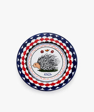 Palio Dinner Plate. Glazed ceramic in red and navy designs with porcupine motif.