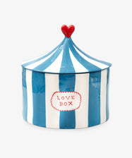Love Box by Laetitia Rouget. Hand-painted ceramic box shaped like a circus tent in white and blue stripes with heart on top.