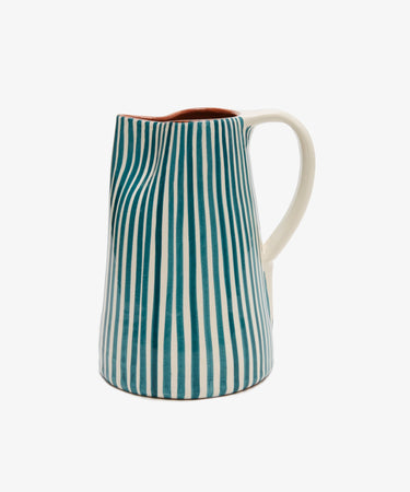 The Natalia Water Jug features blue vertical stripes and a white handle on a white background, displayed against a plain backdrop.