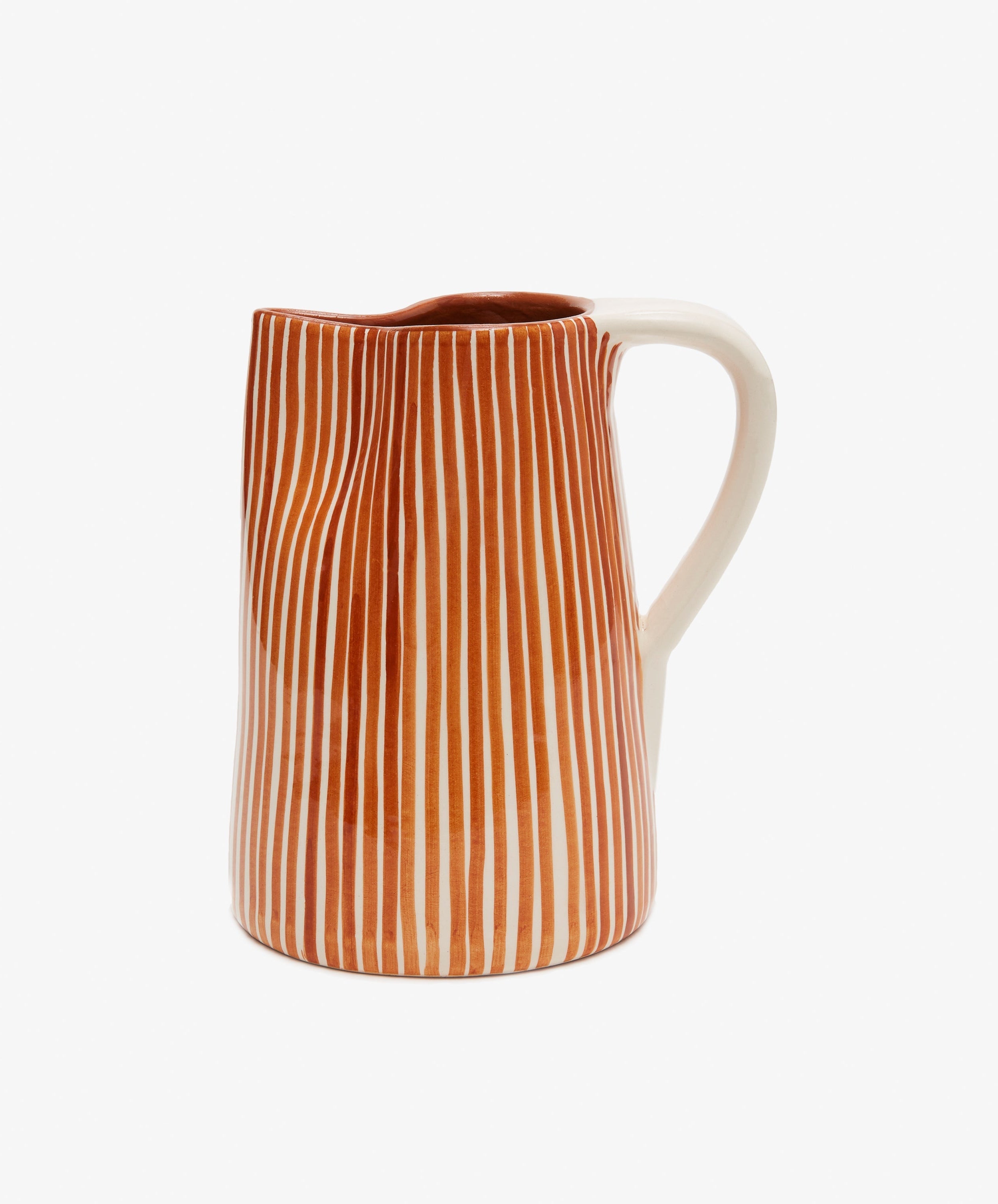 The Natalia Water Jug features vertical orange and white stripes with a white handle, displayed against a plain white background.