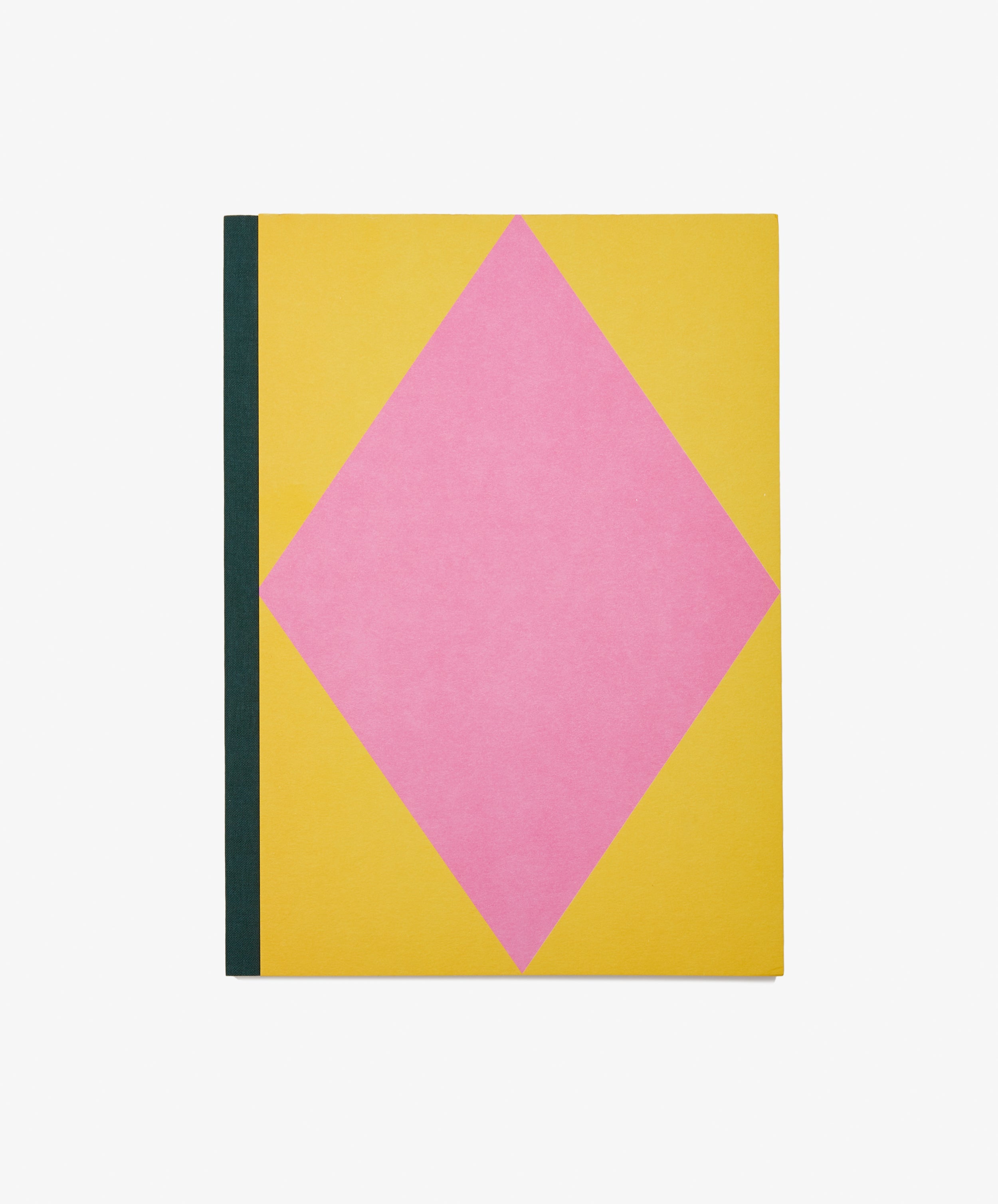 Dreamer's Notebook by Positional. Rectangular book with yellow background, pink diamond, and navy bound spine.
