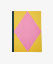 Dreamer's Notebook by Positional. Rectangular book with yellow background, pink diamond, and navy bound spine.