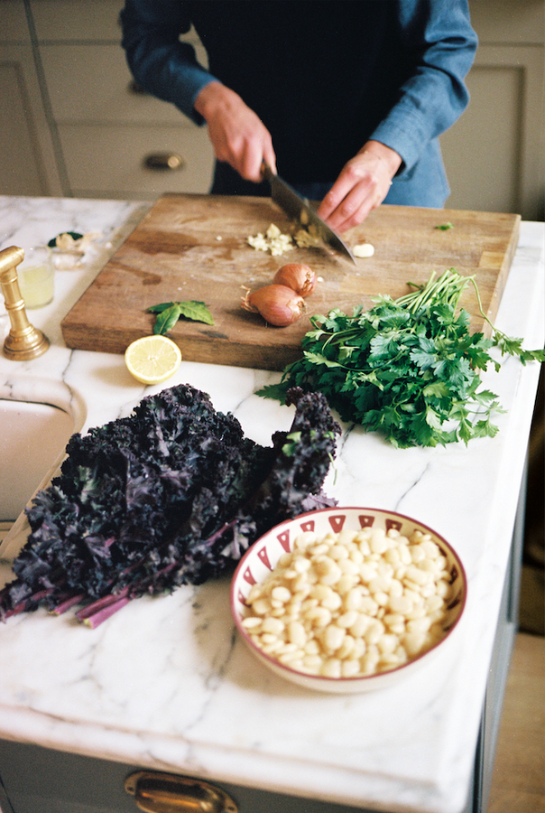 woman chopping produce in kitchen