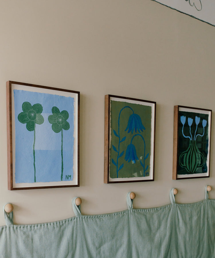 three floral paintings on wall