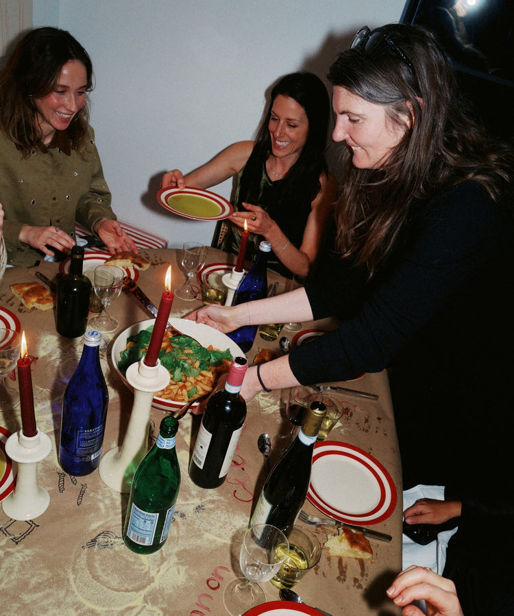 woman serving pasta at the table