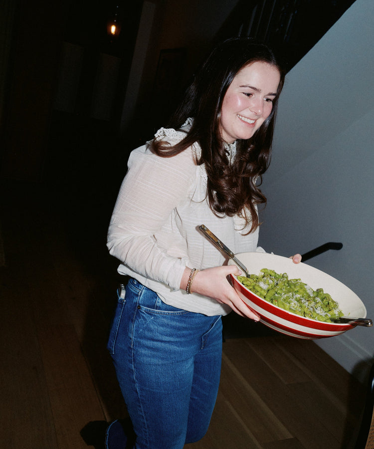 woman carrying pasta in bowl