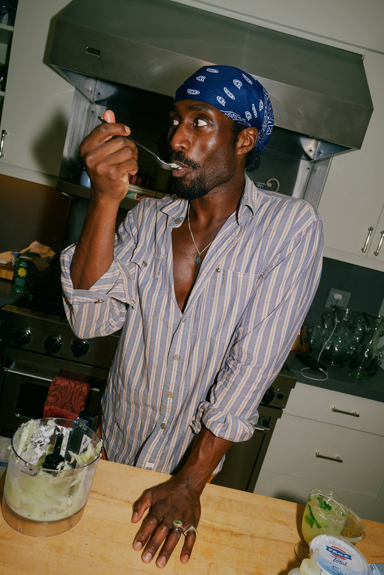 Chef in kitchen tasting his food