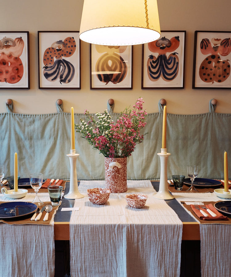 table with plates and art hanging