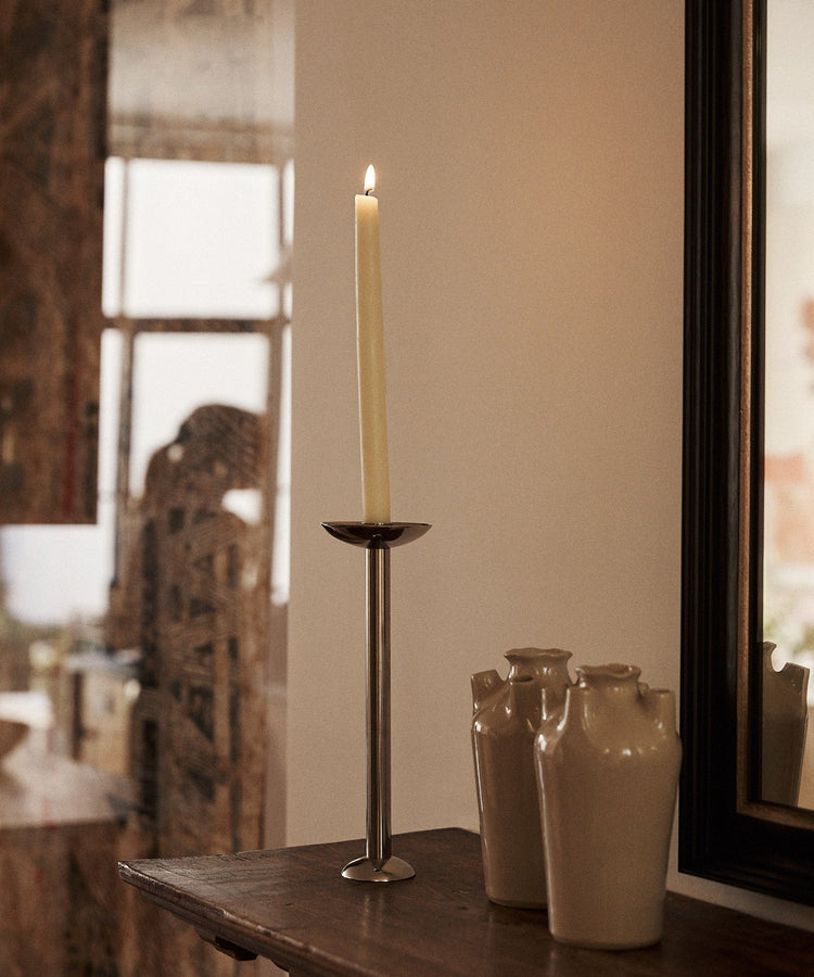 candle in a candleholder on the mantle lit