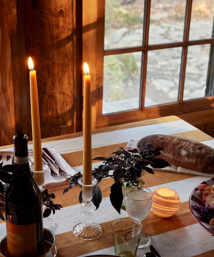 lit candles and plates on table