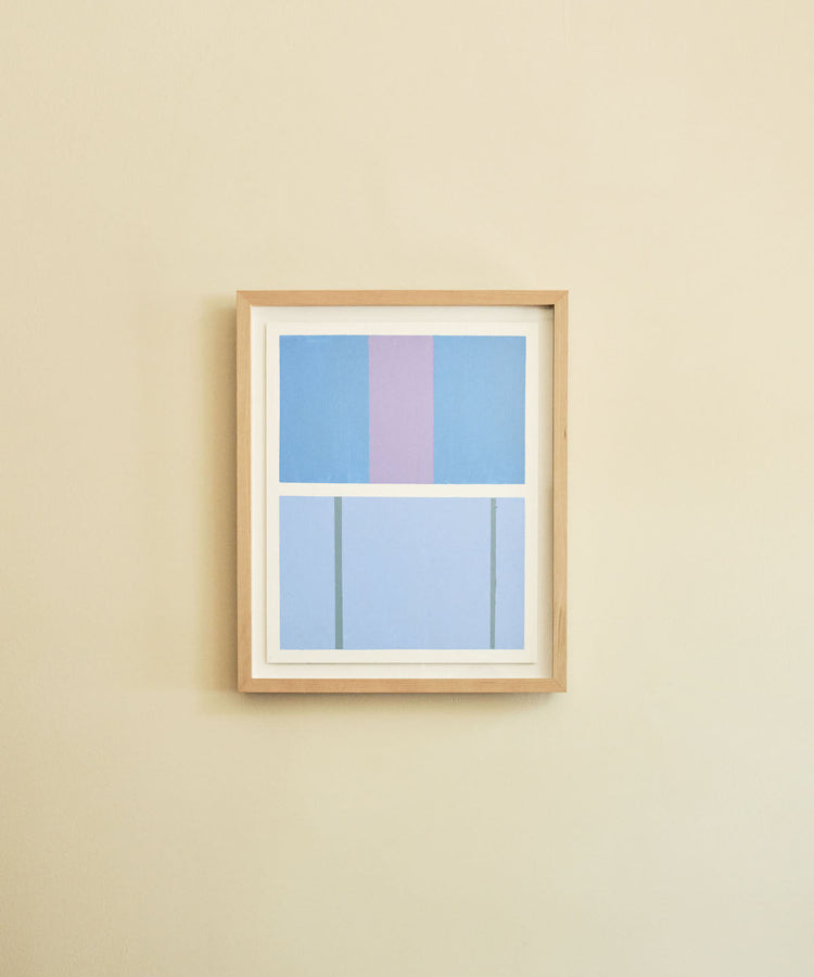 Framed abstract artwork with blue and purple geometric blocks on a beige wall