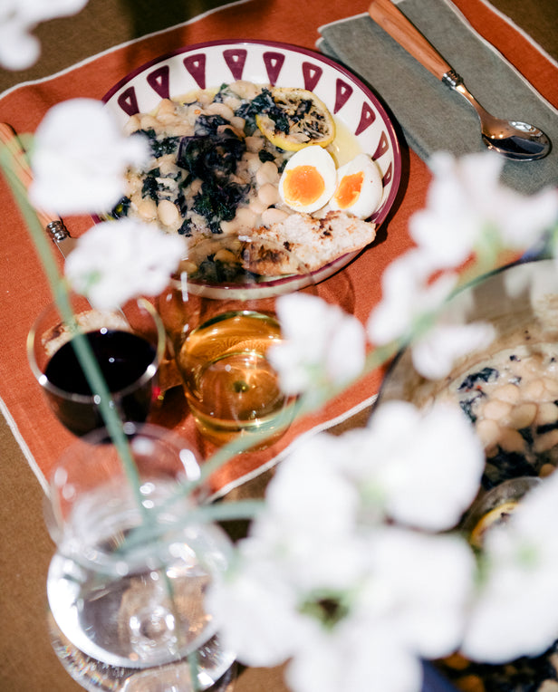 bowl of stew and egg on placemat