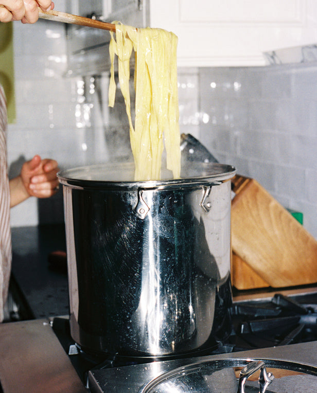 hands cooking pasta