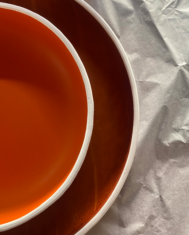 two red ceramic bowls