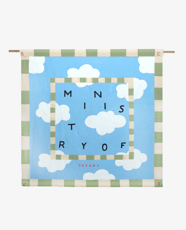 blue quilt with clouds and black letters on it
