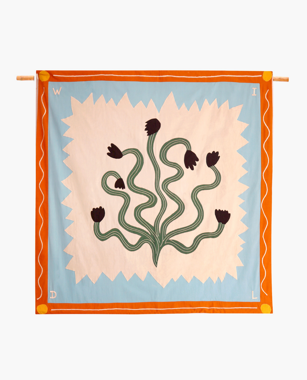 quilt with cactus flowers and blue and white zigzags