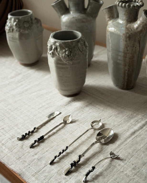 ceramic vases and silver spoons