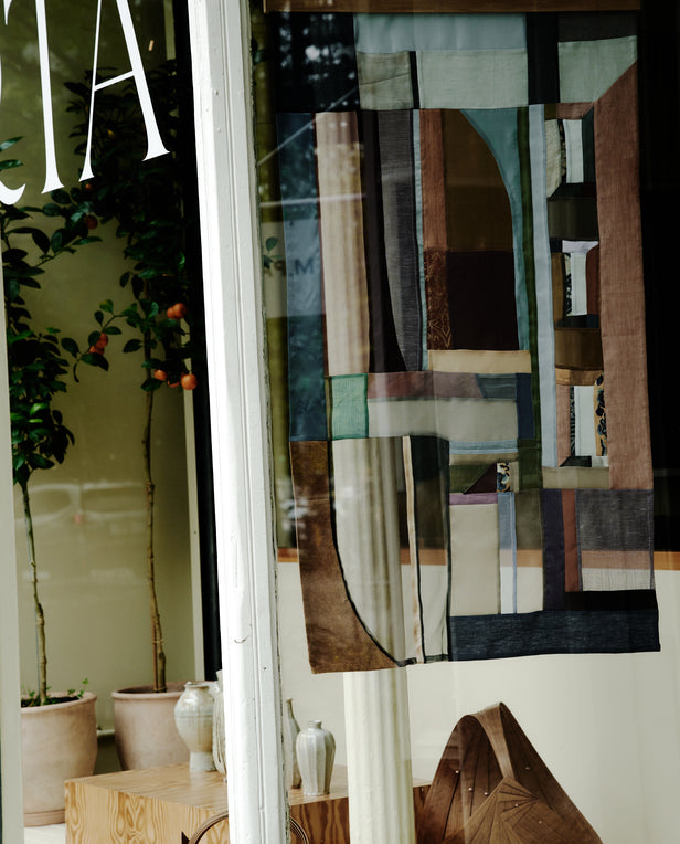 window display with hanging quilt
