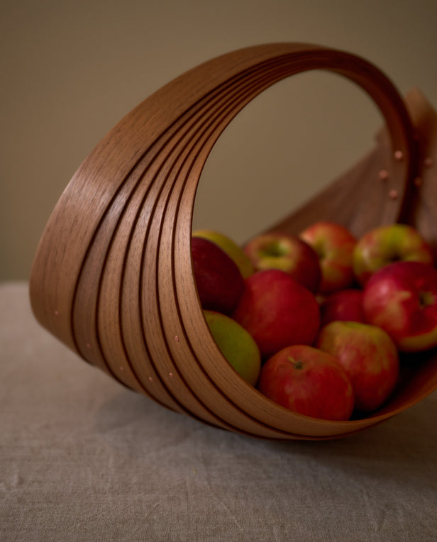 wood basket with apples in it