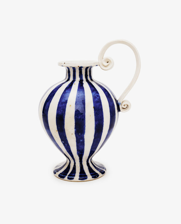 Blue and white striped pitcher with a handle on a white background