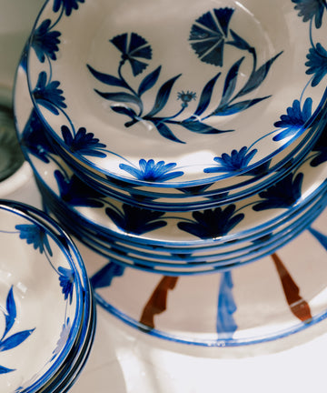 Set of 4 Catalina Dinner Plates, crafted from white ceramic with blue floral patterns, embodying the charm of Portuguese dinnerware and neatly arranged in a stack, viewed from above.