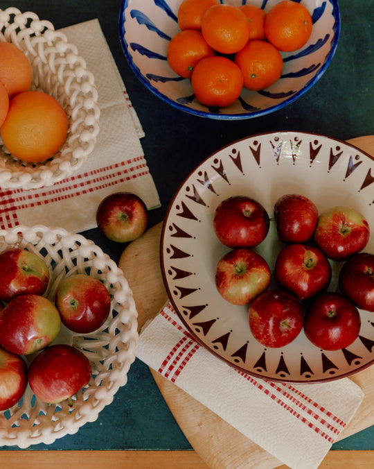 four bowls with apples and oranges in them