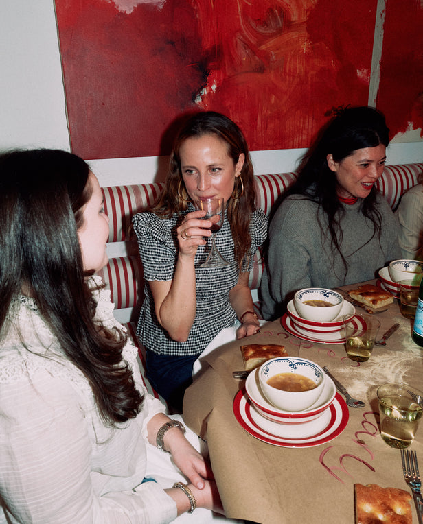 three woman talking at a dinner table