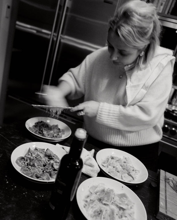 woman having cheese on pasta dishes