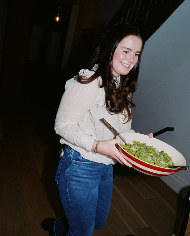 woman carrying pasta in bowl