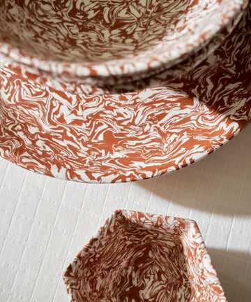 Three Celine Serving Platters, each handcrafted with red and white Aptware marbled patterns, are arranged on a textured white surface and viewed from above.