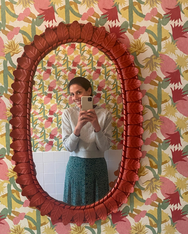 woman looking in mirror taking selfie