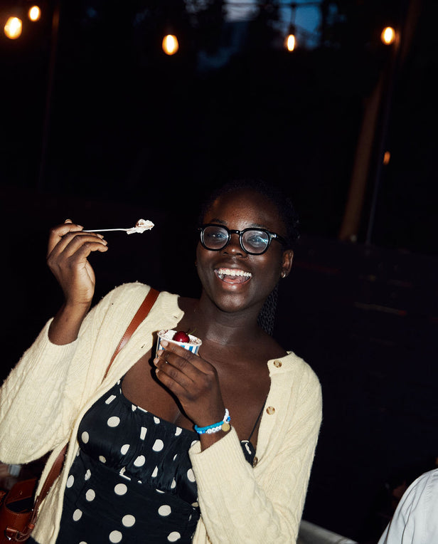 Woman enjoying ice cream at a nighttime outdoor event
