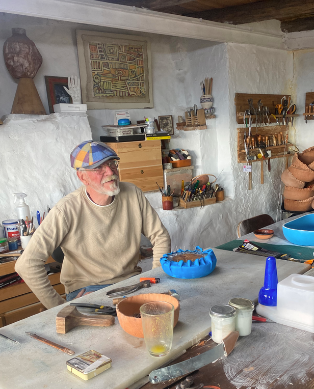 man in artist studio making ceramics