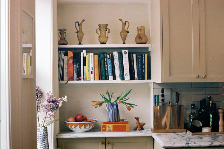 kitchen nook with cookbooks and vases