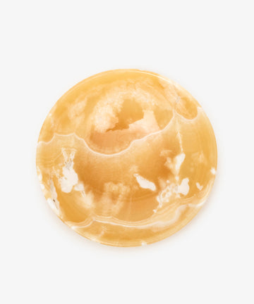 The Akila Decorative Bowl, crafted from round, polished yellow and white agate, stands out on a plain white background—perfect as a unique, handcrafted home decor piece.